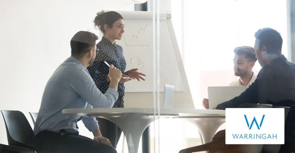 Business people listening to a young ethnic woman giving a presentation Business people listening to a young ethnic woman giving a presentation