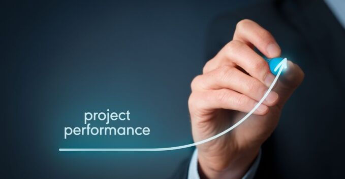 Close up of hand drawing an arrow pointing up with Project Performance written on it