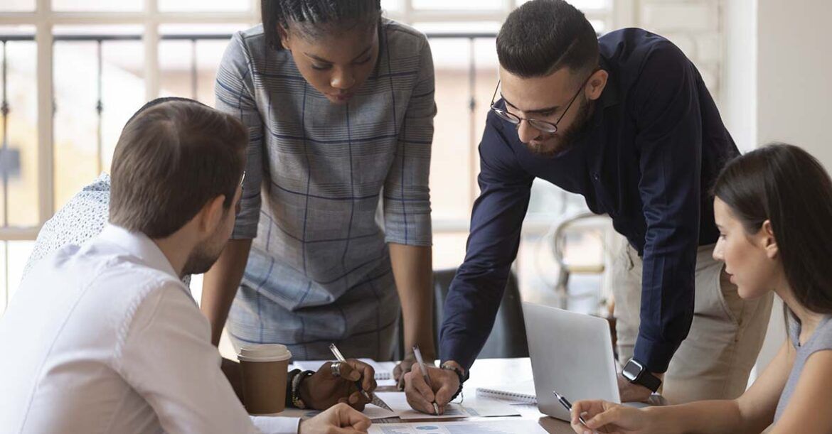 Focused multiracial corporate business team people brainstorm on paperwork