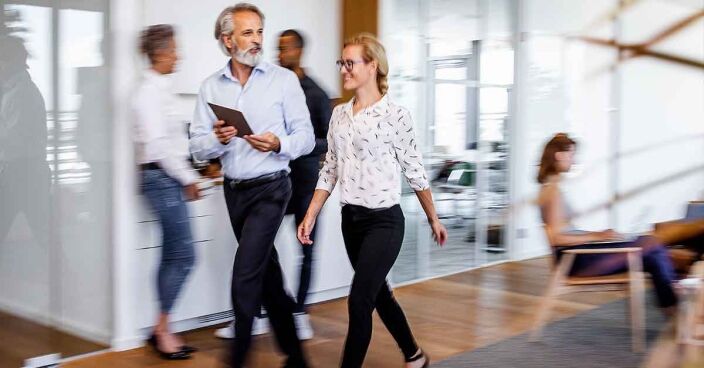 Business people discussing while walking Business people discussing while walking