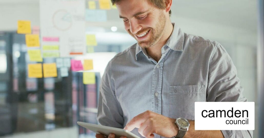 Smiling business man looking at this tablet device Smiling business man looking at this tablet device