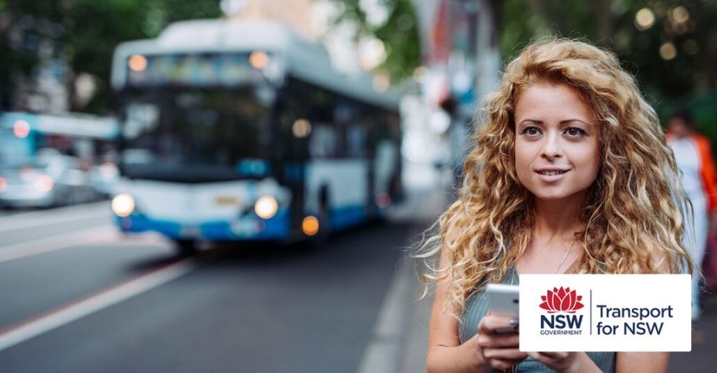 Woman using mobile app on bus stop Woman using mobile app on bus stop