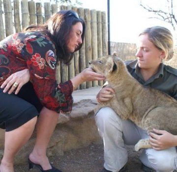 women patting a cub
