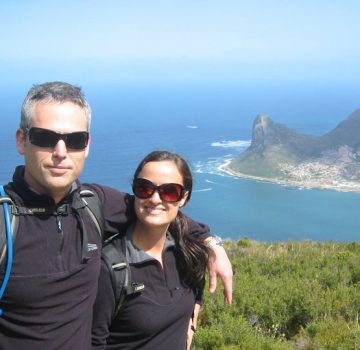 a couple standing on top of the cliff