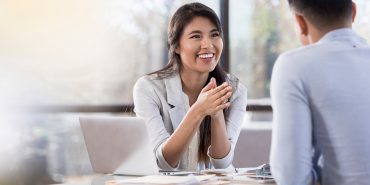 Cheerful buisnesswoman meets with colleague