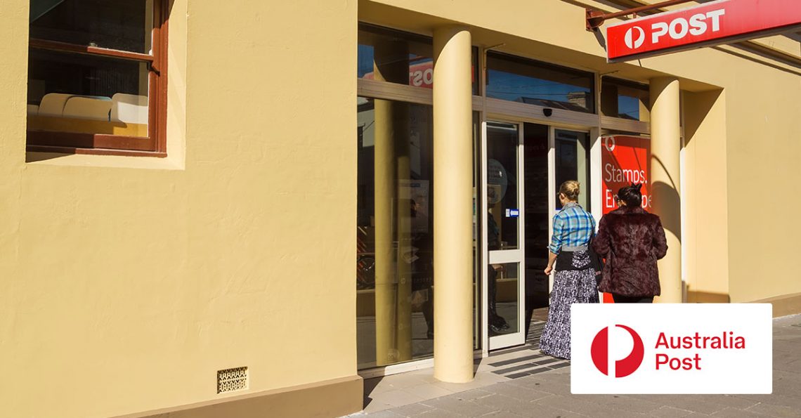 People walking inside the Australian Post office