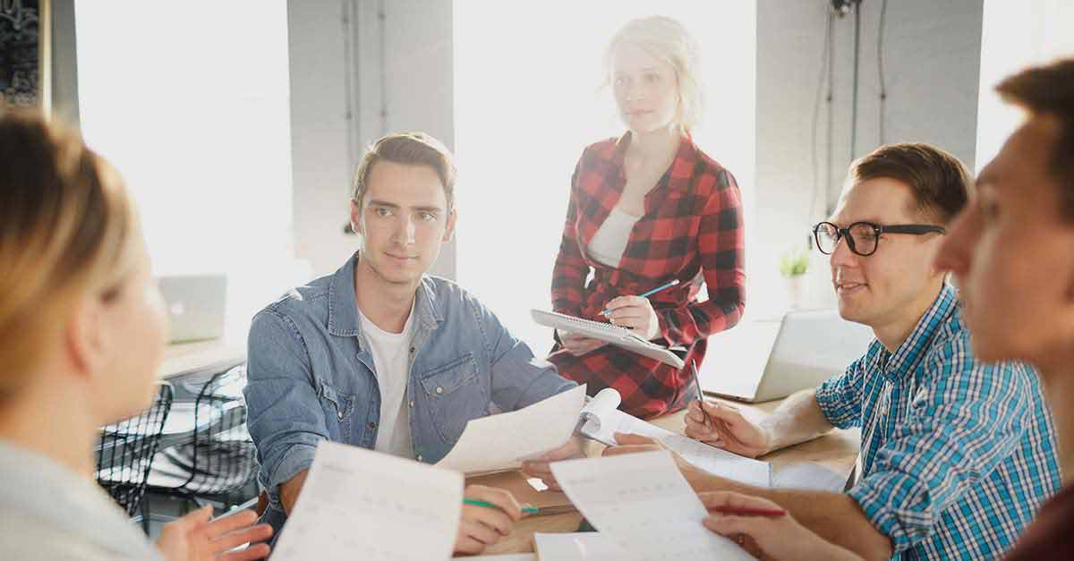 Casually dressed colleagues going over the paperwork Casually dressed colleagues going over the paperwork