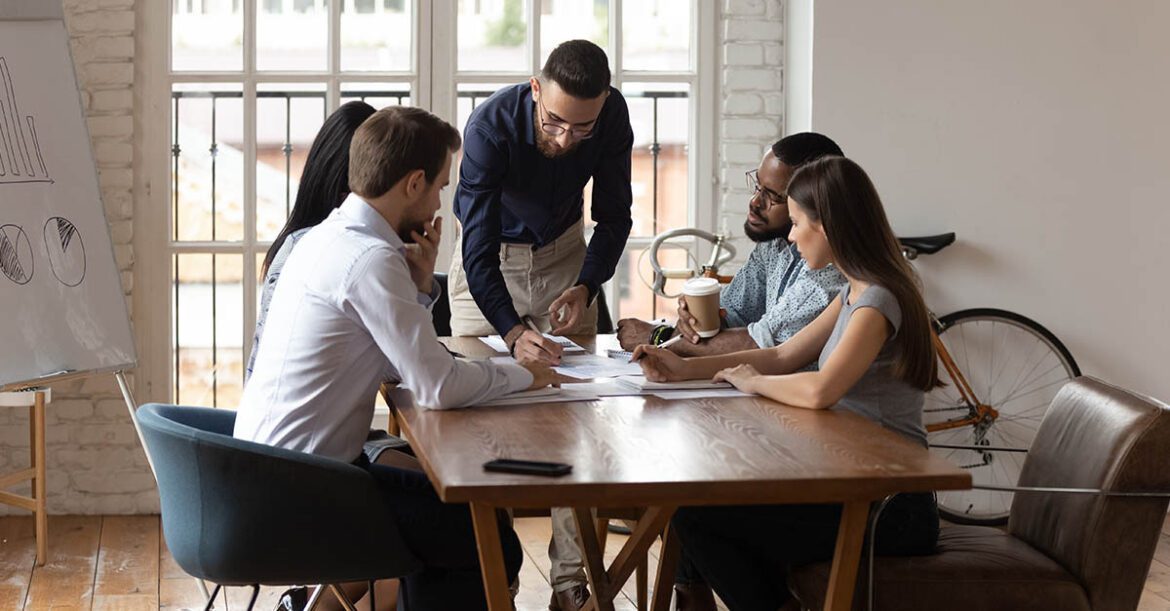 Diverse business team working at group meeting in modern office