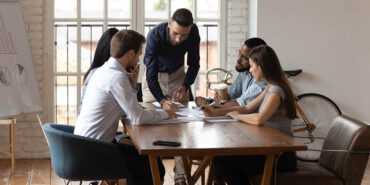 Diverse business team working at group meeting in modern office