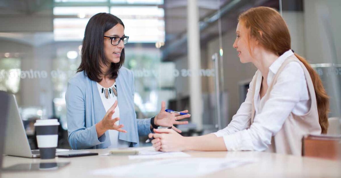 Business woman explaining something to another female colleague
