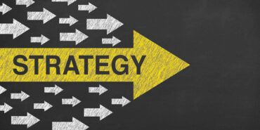 Strategy concepts with arrows on chalkboard background