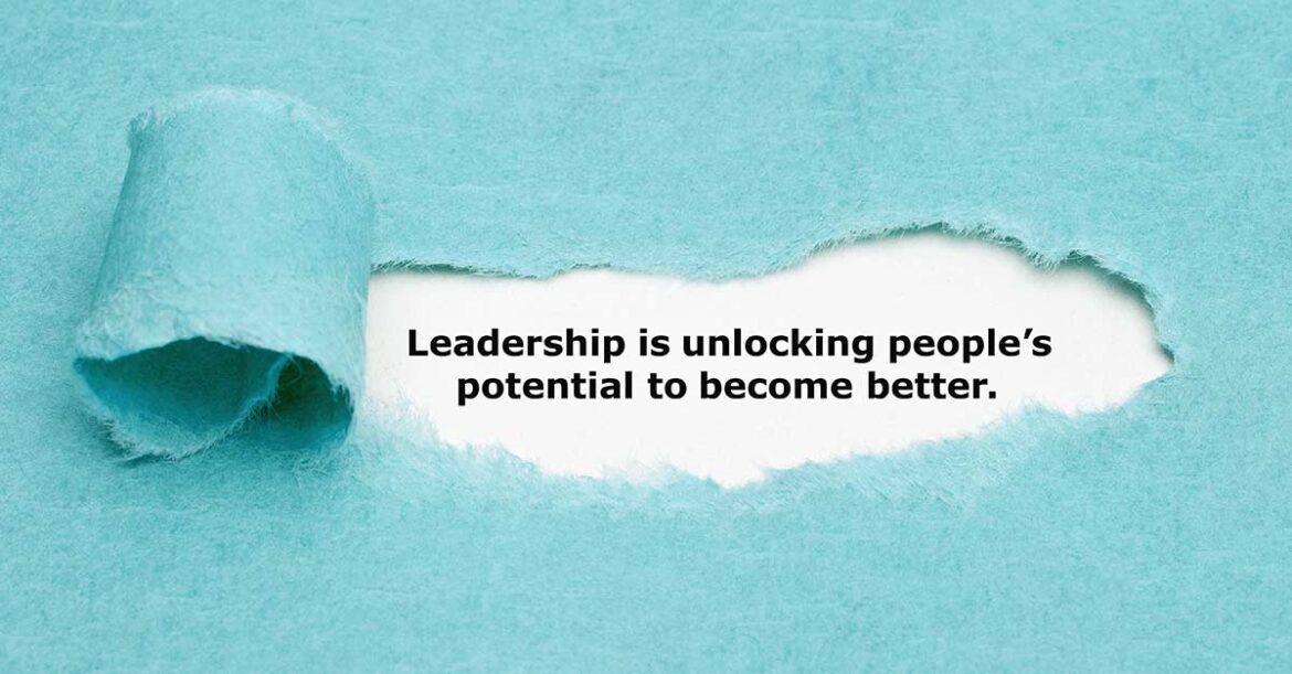Leadership Is unlocking people's potential to become better written under the ripped paper