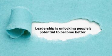 Leadership Is unlocking people's potential to become better written under the ripped paper
