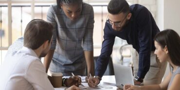 Focused multiracial corporate business team people brainstorm on paperwork