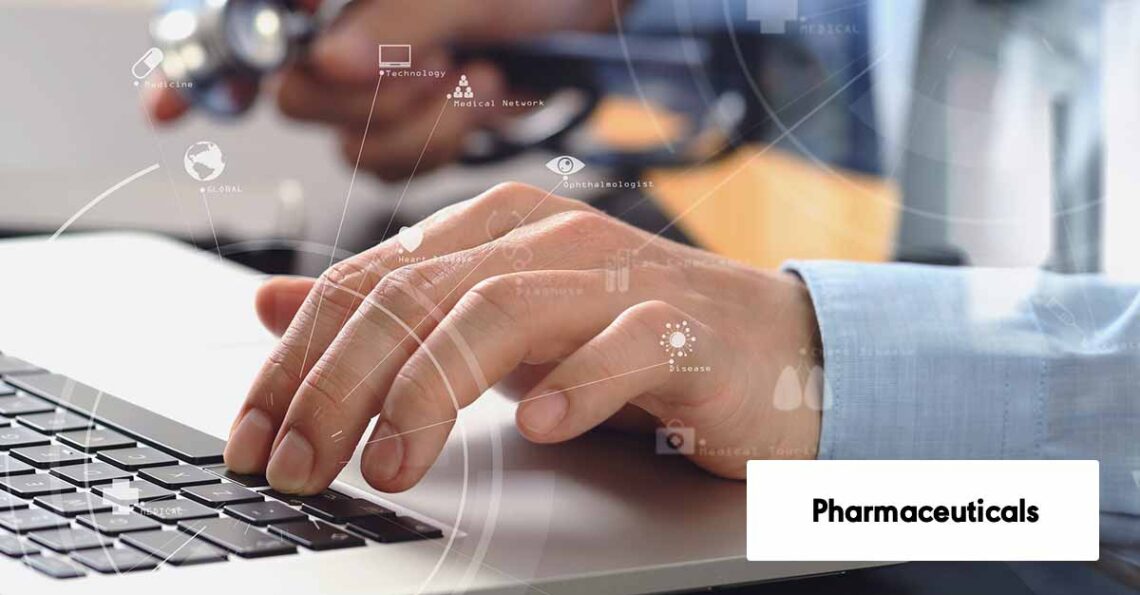 Close up of smart medical doctor working with laptop computer and mobile phone and stethoscope on dark wooden desk