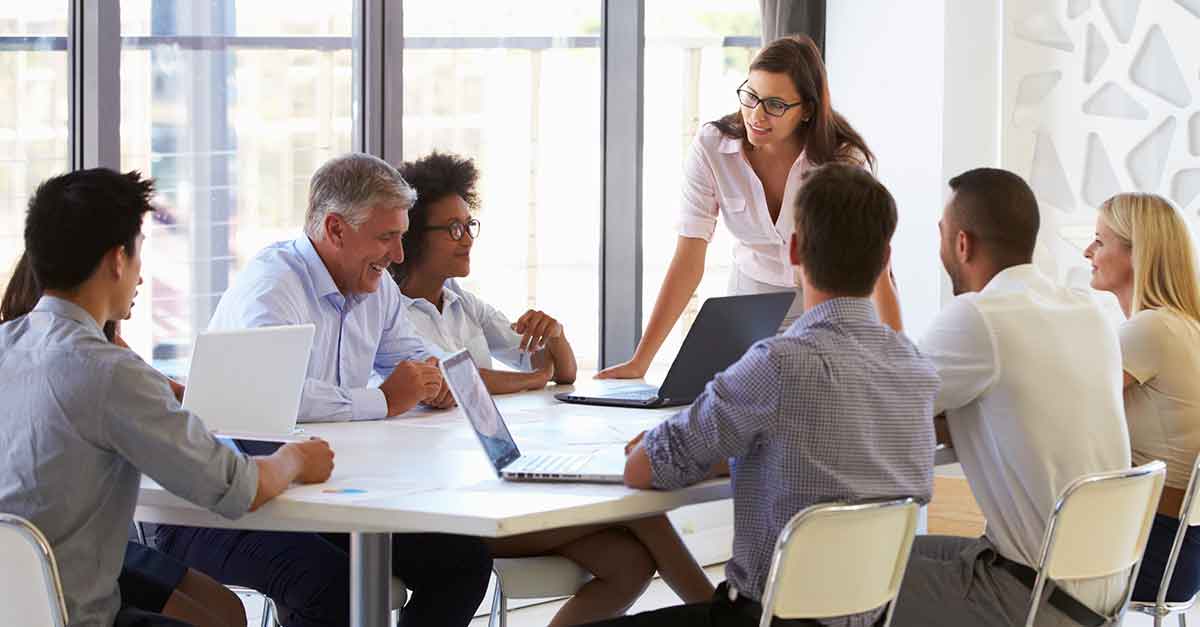 Business woman presenting to colleagues at a meeting