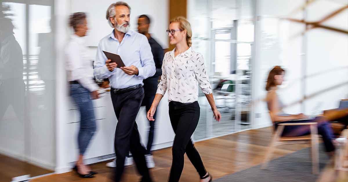 Business people discussing while walking