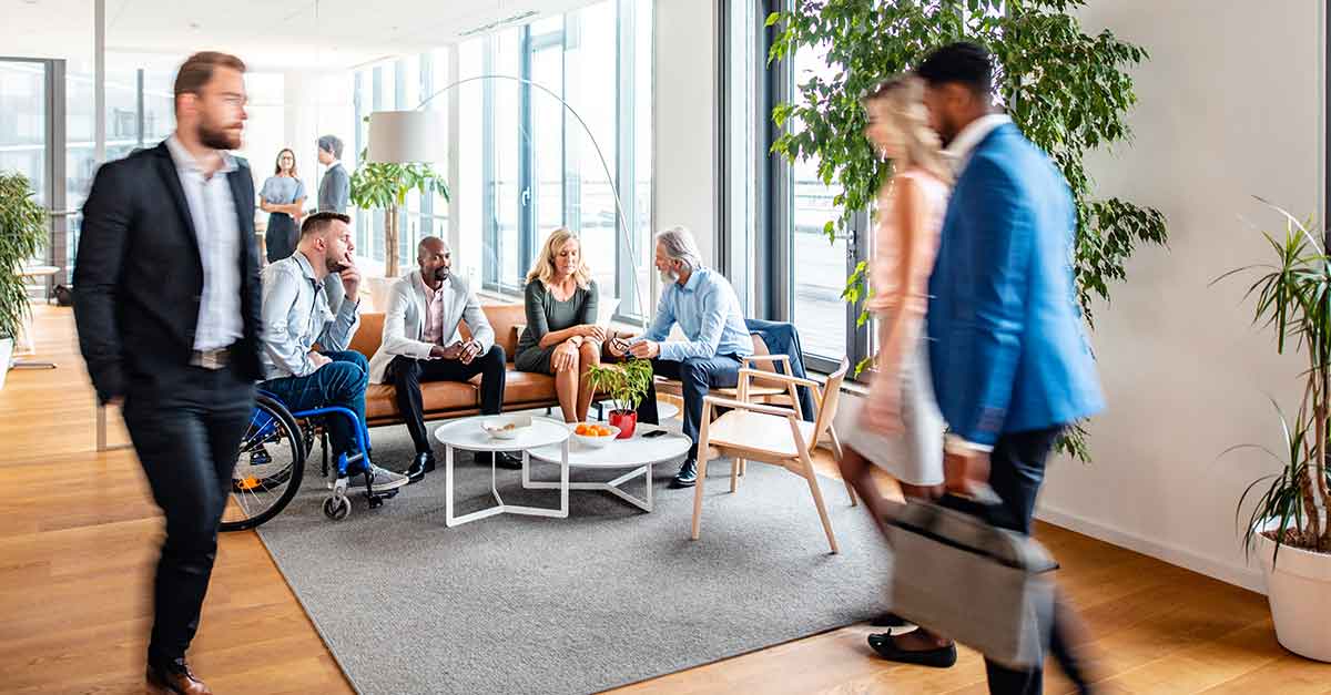 Business people coming and going through office lobby