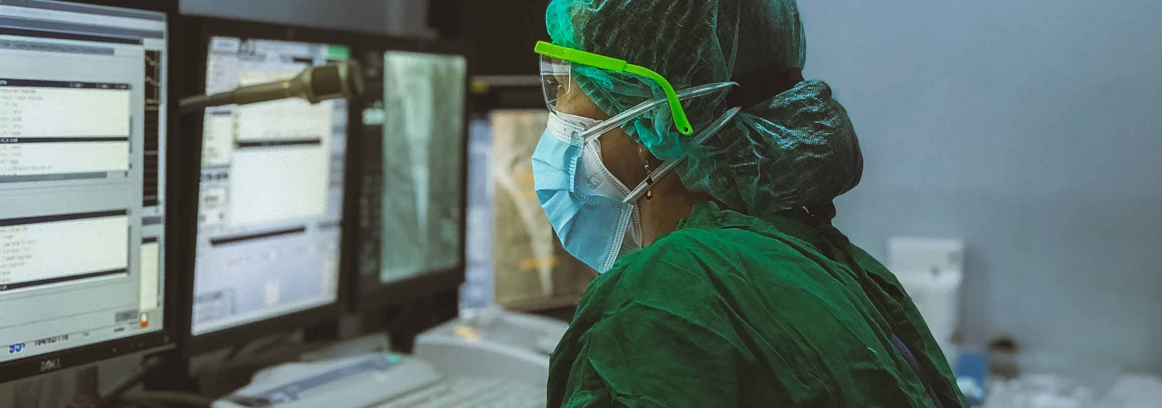 Medical staff in scrubs working on a computer