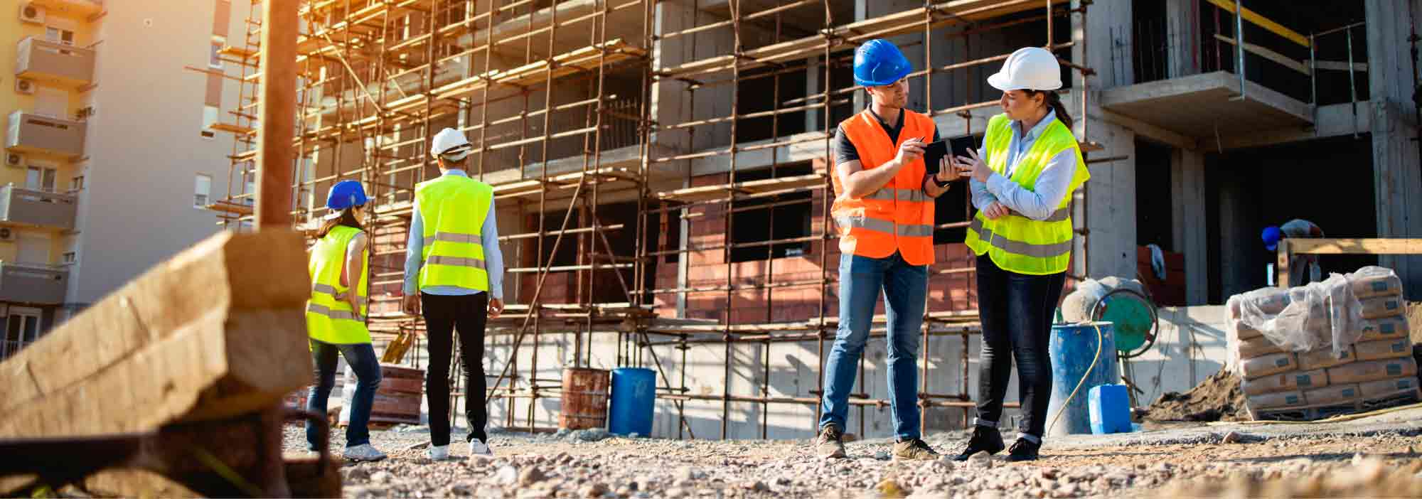 Four construction workers having meeting