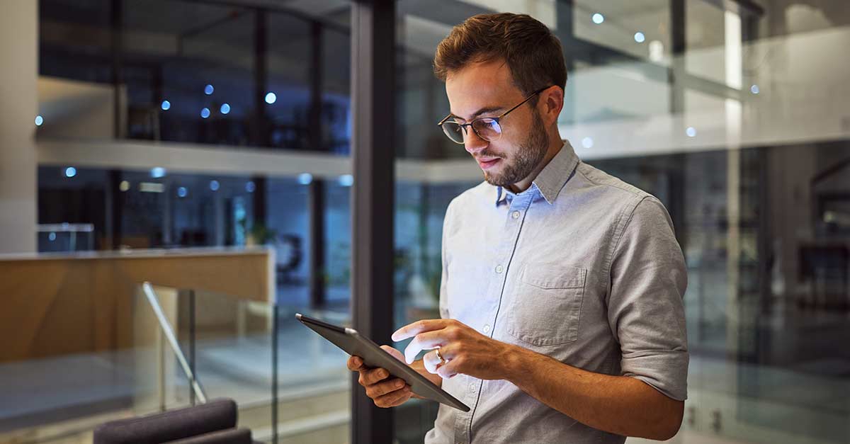 Man in office, working on tablet in the office